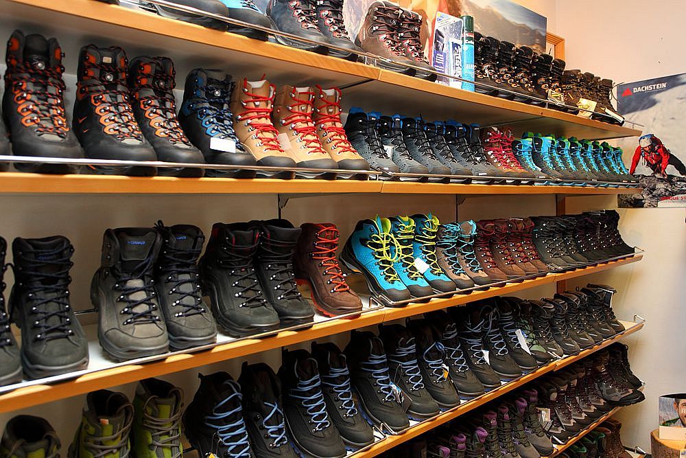 Hiking boots on shelves in the sports shop